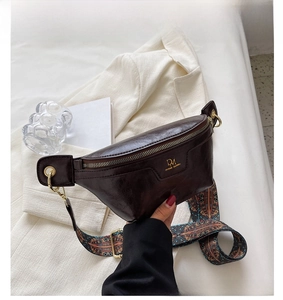 Close-up of dark brown faux leather waist bag with colorful ethnic pattern strap