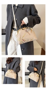 Detail view of beige Hanfu bag with bird and bamboo embroidery and metal handle