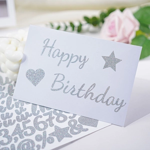 Silver glitter letter stickers used on a Happy Birthday card with elegant decorations