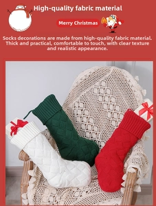 Three large knit Christmas stockings in red, green, and white with textured diamond patterns