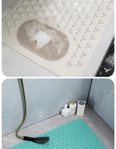 Detail of beige bath mat with massage texture and anti-slip suction cups in a shower