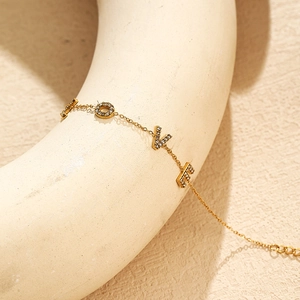 Elegant gold-plated stainless steel LOVE bracelet with zircon stones on art display