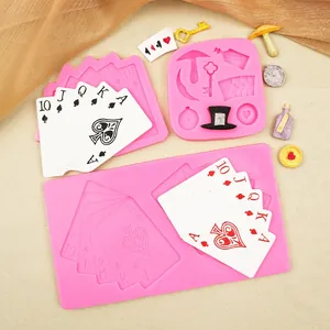 Three pink silicone molds featuring poker cards, magic hats, and key shapes for DIY baking