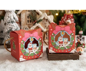 Close-up of red hollow Christmas gift boxes with Santa Claus and reindeer on faux snow