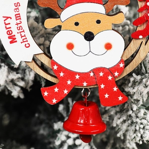 Wooden Christmas reindeer ornament with red bell and Merry Christmas sign on snowy pines