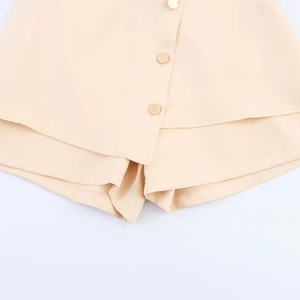 Elegant beige asymmetrical skort with decorative gold buttons and irregular hem design