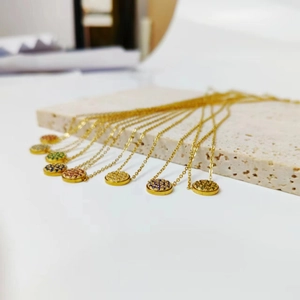 Detail of colorful birthstone necklaces with micro-paved crystals on gold chains