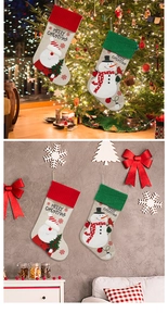 Close-up of linen Christmas stockings with Santa and Snowman hanging on a festive tree