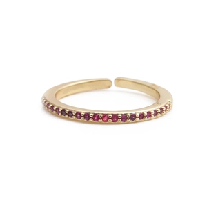 Detailed view of adjustable gold ring featuring a row of sparkling red zircon stones