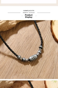 Detailed view of handmade leather soccer necklace with metallic star beads and football charm