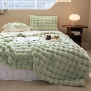 Close-up of soft light green Tuscany faux fur blanket with 3D bubble texture detail