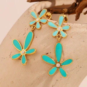 Detailed shot of mint green flower earrings with gold plating and white zircon inlay