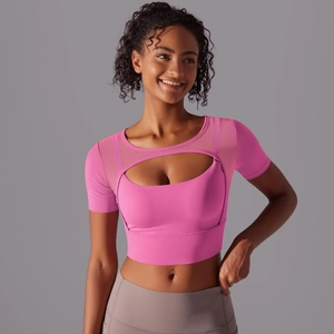 Detail view of pink crop top with crescent cutout and breathable mesh stitching
