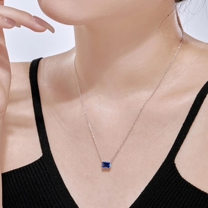 Vue macro d'un collier en argent S925 avec pierre bleue rectangulaire sur un mannequin