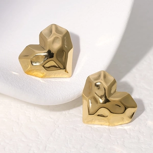 Minimalist gold heart-shaped stud earrings with geometric faceted metal texture