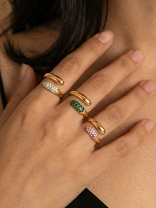 Detail of adjustable gold ring with pavé-set white, green and pink cubic zirconia