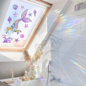 Rainbow mermaid tail static glass stickers projecting colorful light on bathroom tiles