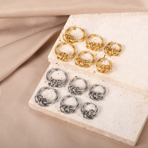 Set of 12 pairs gold and silver polished hoop earrings on elegant silk and stone display