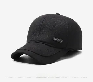 Detail of black winter baseball cap showing herringbone texture and ear protection