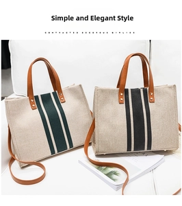 Detail of striped canvas tote bags with leather handles and gold rivet accents
