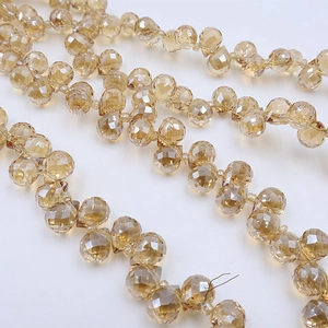 Macro detail of amber faceted glass strawberry beads for DIY jewelry and accessory making