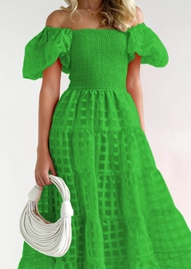 Detail of green off-shoulder dress featuring bubble sleeves and plaid textured fabric