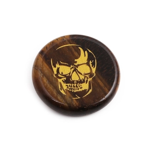 Polished round tiger eye stone pendant with a detailed golden skull engraving