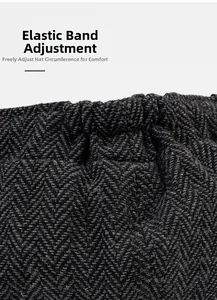 Detail of adjustable elastic band on dark grey herringbone newsboy cap for custom fit