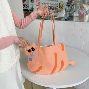 Close-up of cute cartoon cat tote bag featuring 3D tail and detailed embroidery