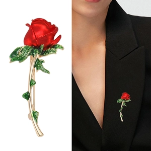 Elegant red rose brooch with gold stem and rhinestones on black suit lapel