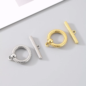 Detailed macro view of gold and silver textured toggle clasps for jewelry making