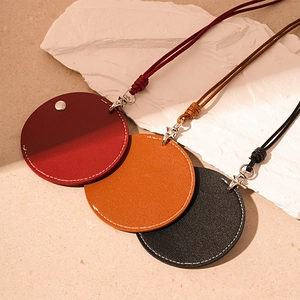 Retro artificial leather round pouch necklace in burgundy, caramel, and black with neck strap