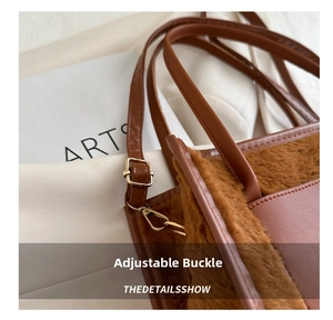 Detail view of the brown plush tote bag showing the gold metal buckle and leather strap