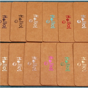 Macro shot of colorful Hello smile patterns printed on blank kraft paper jewelry cards
