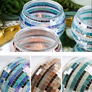 Macro view of mosaic glass candle holders in blue, gold, and green showing texture