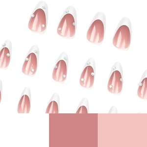 French tip almond press-on nails in nude pink with rhinestone accents and white edges