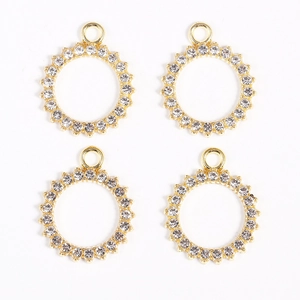 Detail of four gold-plated round pendants with sparkling micro-pave rhinestones for jewelry DIY