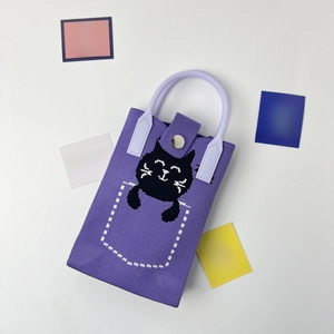 Close-up of lavender knitted phone bag featuring a cute black cat and top handles