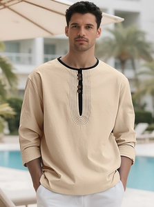 Detail of men's beige linen Henley shirt featuring black contrast collar and buttons