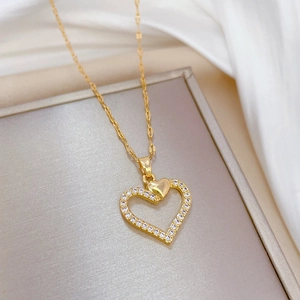 Elegant gold titanium steel heart necklace with cubic zirconia pendant on white silk