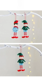 Detail of cloth Christmas elf ornaments with striped socks and pointed hats on festive background