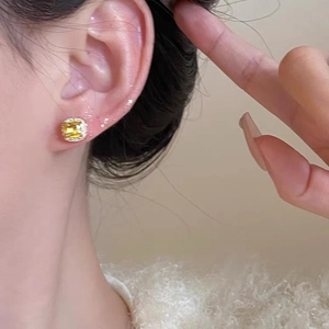 Elegant square yellow zircon stud earrings with silver metal finish on a model side view