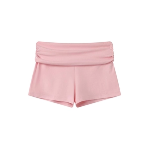 Detail of pink knitted yoga shorts with rhinestone accents and fold-over high waistband