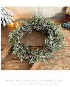 Close-up of frosted Christmas wreath with pine cones on a rustic wooden background