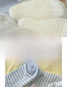 Detail showing seamless toe construction and embroidery on striped crew socks