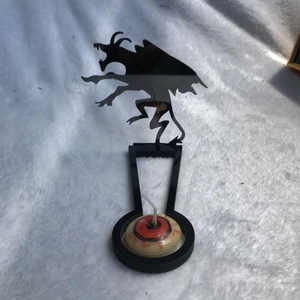 Macro shot of Halloween candle holder with a devil silhouette and eyeball patterned candle