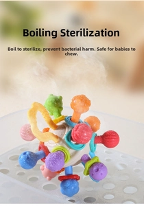Baby sensory teether ball being steam sterilized in a white tray for hygiene