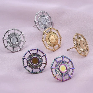Macro detail of sunburst stainless steel stud earrings in silver, gold, and rainbow finishes