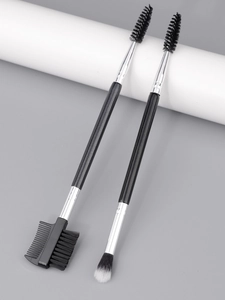 Close-up of dual-ended eyebrow brushes with spoolie and comb on a minimalist background