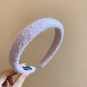 Detailed close-up of handmade lavender plush headband showing soft curly fleece texture